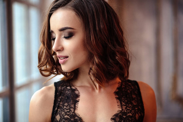 Portrait of sensual young woman in a black lacy negligee in classic interior - Foto, Imagem