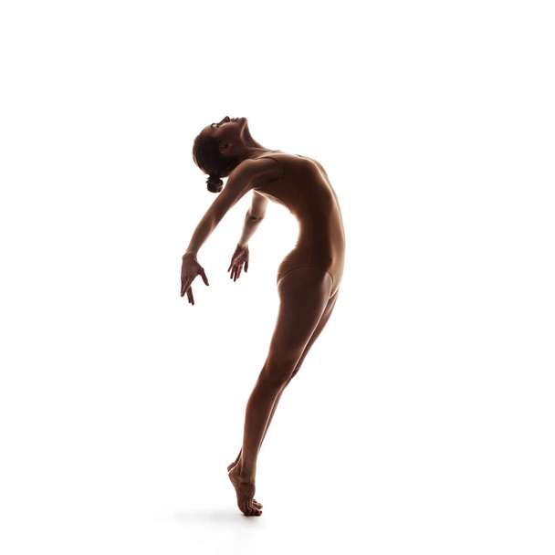 young beautiful dancer in beige swimsuit posing - Foto, afbeelding