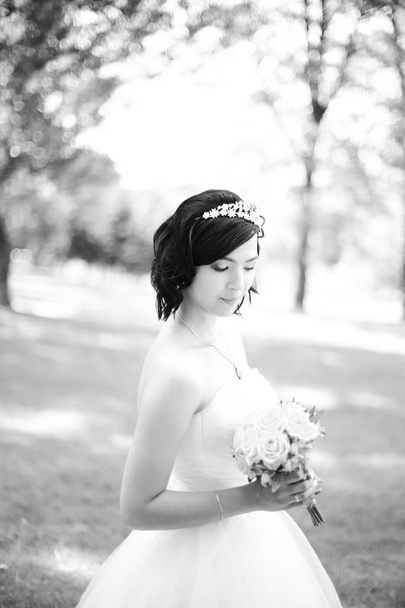 black and white photo.young bride in a luxurious dress - Fotó, kép