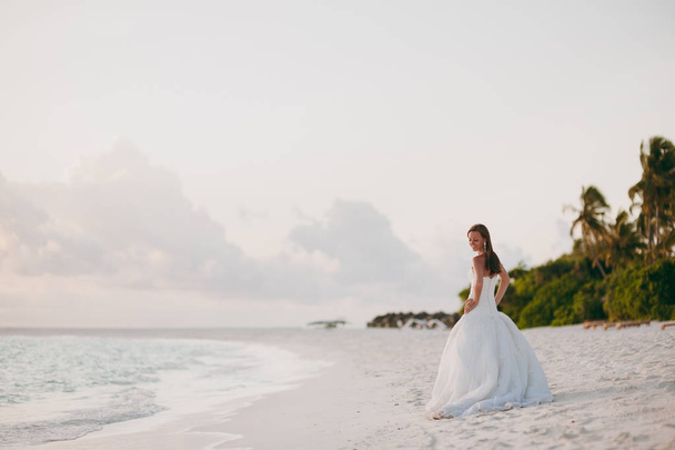 Beautiful bride on the beach of the island - Фото, изображение