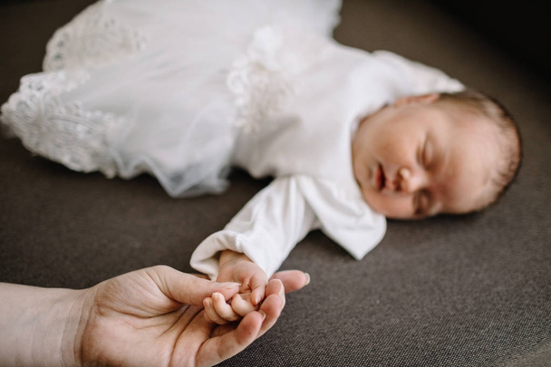 Hand baby in the hand of mother closeup. concept love of family. - 写真・画像