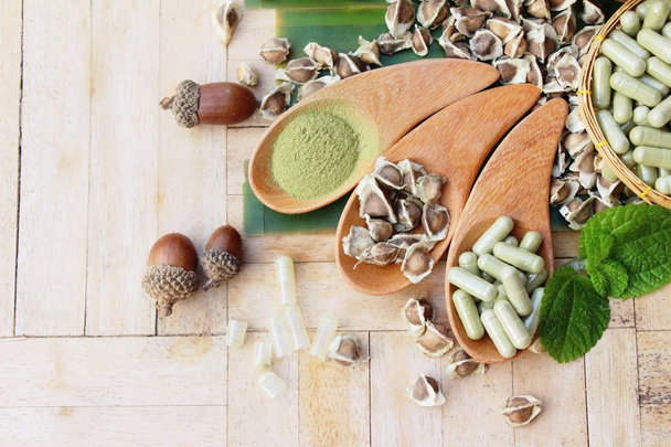 Moringa capsule for health on wood background - Photo, Image