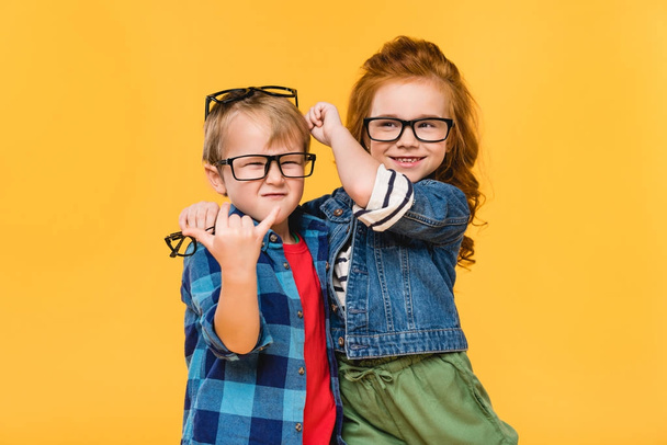 portrait d'enfants souriants dans des lunettes isolées sur jaune
 - Photo, image