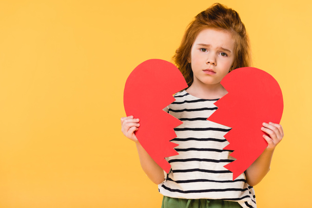portrait of sad child with broken red paper heart isolated on yellow, st valentines day concept - Foto, imagen
