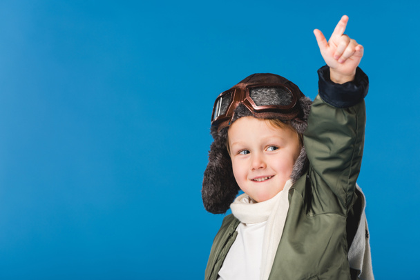 portrait of preteen boy in pilot costume isolated on blue - 写真・画像