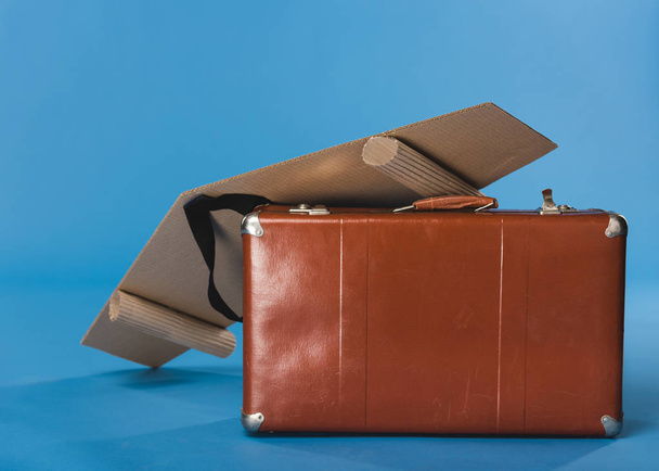 close up view of self made paper plane wings and suitcase isolated on blue - Foto, imagen