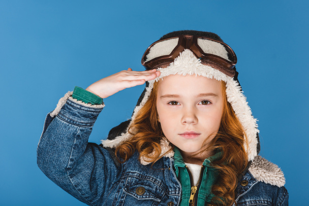 portrait of adorable preteen kid in pilot costume isolated on blue - Photo, Image