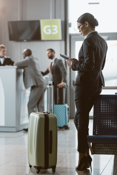 attractive businessman waiting for flight at airport lobby - Photo, Image