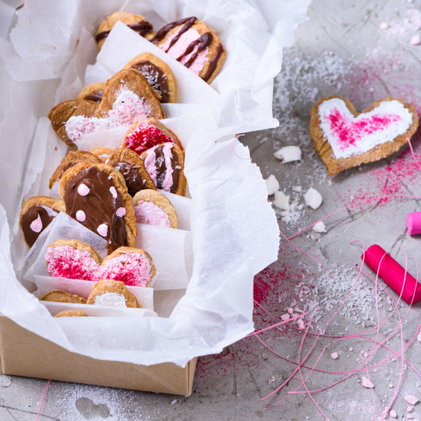 close-up view of collection of sweet heart shaped cookies on grey surface   - Zdjęcie, obraz