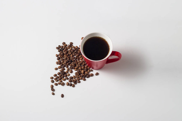 Taza roja con café y granos Café alrededor
 - Foto, imagen