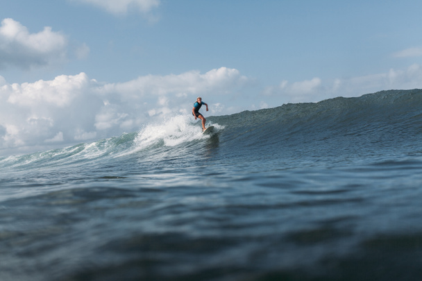 man surfing wave on surf board in ocean  - Φωτογραφία, εικόνα