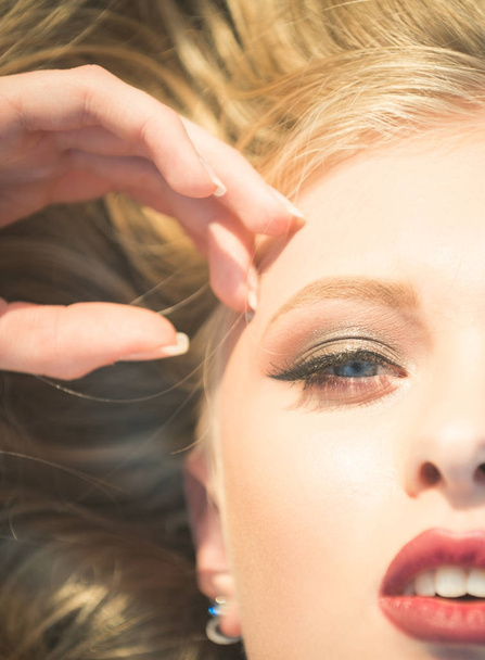 Sensual girl half face with makeup and blond hair - Foto, afbeelding