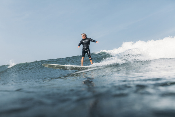 surfer having fun and riding wave on surf board in ocean  - Fotografie, Obrázek