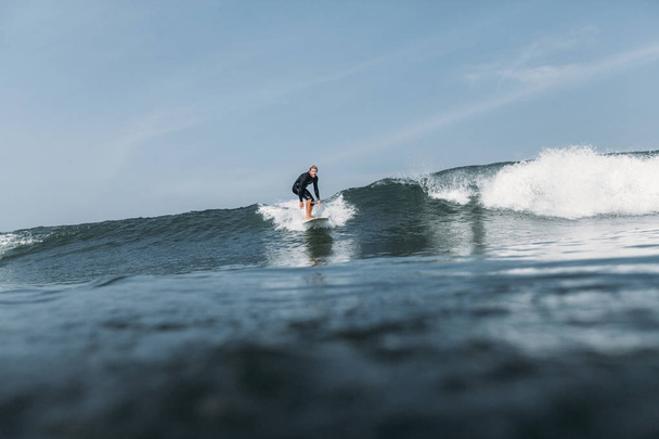 male surfer riding wave on surf board in ocean  - Фото, зображення