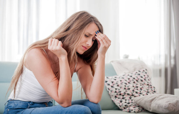Woman at home suffering from headache, emotions and stress - Photo, image