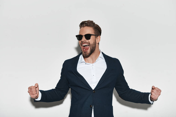 happy handsome man in formal wear gesturing success with opened mouth - Fotoğraf, Görsel