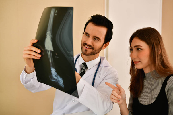 Health Concepts. Doctor and patient viewing x-ray film. The doct - Photo, Image