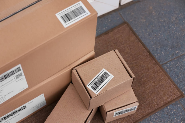 Delivered parcels on doormat, closeup - Foto, Imagem