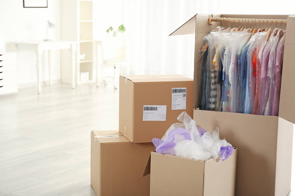 Wardrobe boxes with clothes indoors - Фото, изображение