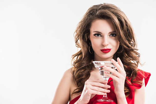 fashionable girl in red dress holding glass of cocktail isolated on white - Foto, immagini