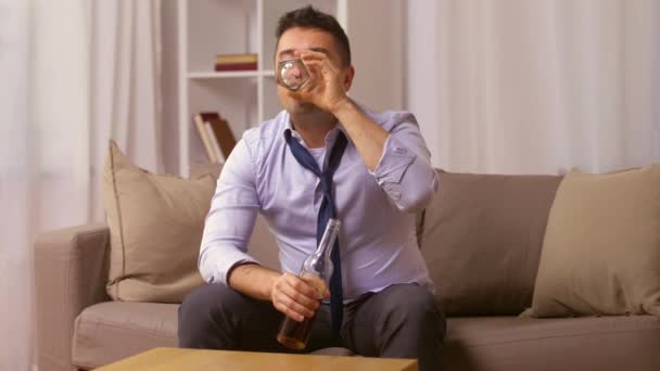 alcoholic with bottle drinking whiskey at home - Video