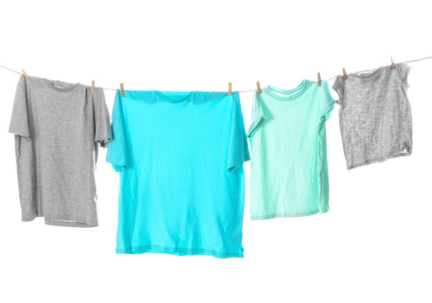 Clothes on laundry line against white background - Foto, Imagen
