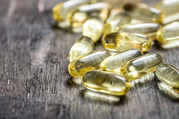 Fish oil capsules with omega 3 and vitamin D. healthy diet conce - Photo, Image