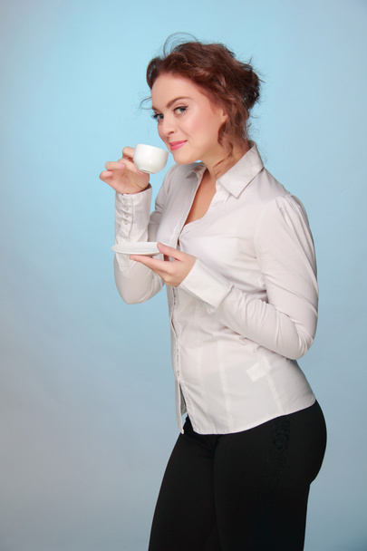 Woman drinking from a cup of coffee - Fotó, kép