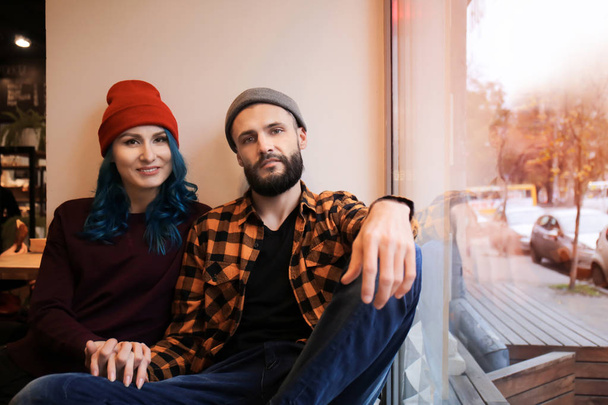 Young hipster couple resting near window in cafe - Fotografie, Obrázek