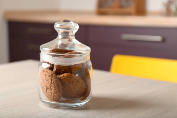 Delicious oatmeal cookies in glass jar on table - Foto, imagen