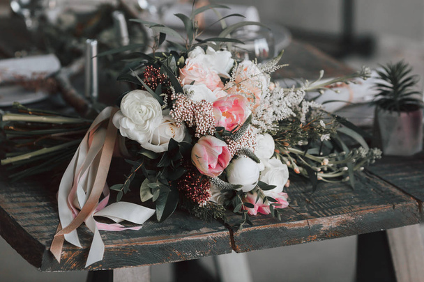 The rustic bouquet on an aged wooden table. Artwork. - Fotografie, Obrázek