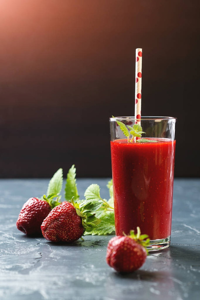 Fresh strawberry smoothie in a glass on black background. - Fotoğraf, Görsel