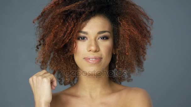 Pretty ethnic woman touching hair - Filmati, video