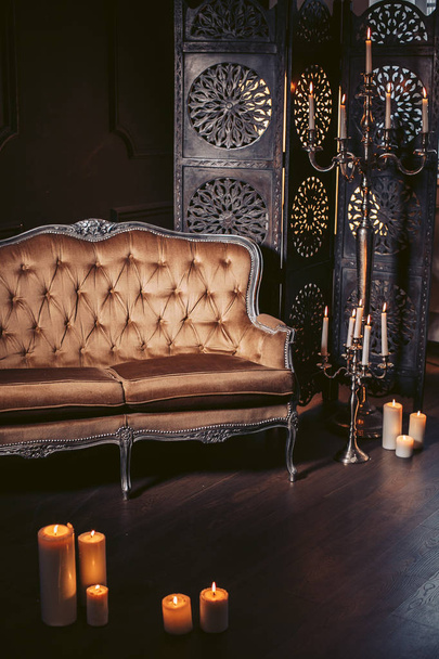 Luxurious sofa in a modern interior, decorated with decor and candles - Zdjęcie, obraz
