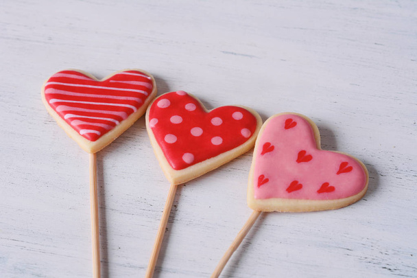 Close up of heart shaped lollipop on wooden background. Valentine's day concept - Foto, Imagem