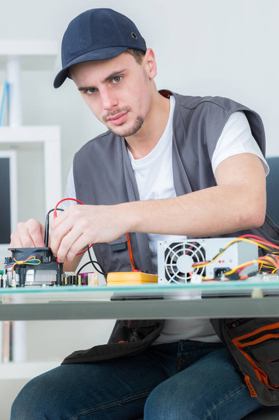 electronic engineer repairing electronic devices on broken computer - Фото, изображение