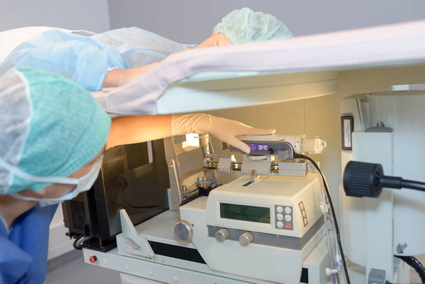 Woman on hospital stretcher above diagnostic machines - Foto, imagen