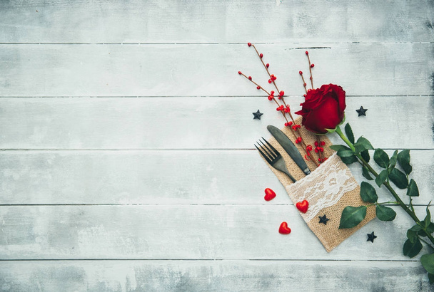 Fork, knife, napkin, heart. Celebrate valentine's day. Serving, Table decoration Valentine's Day, table set with a decorative heart. Image of dinner on Valentines day. Top view, copy space. - 写真・画像