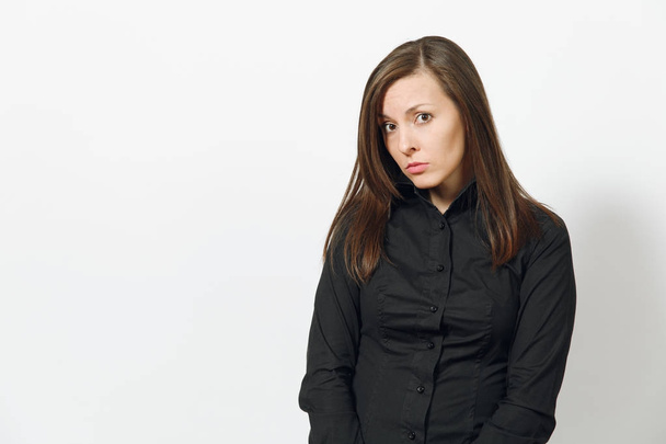 Beautiful serious upset sad caucasian young brown-hair business woman in black classic shirt, skirt isolated on white background close up. Manager, worker, student. Copy space for advertisement. - 写真・画像
