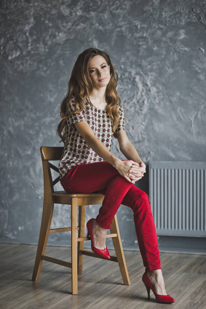 Studio portrait of woman in red jeans 6940. - Photo, image