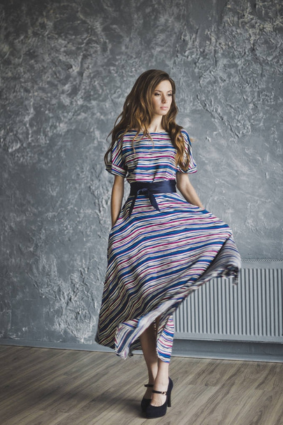 Gorgeous slender girl in a striped dress 6981. - 写真・画像