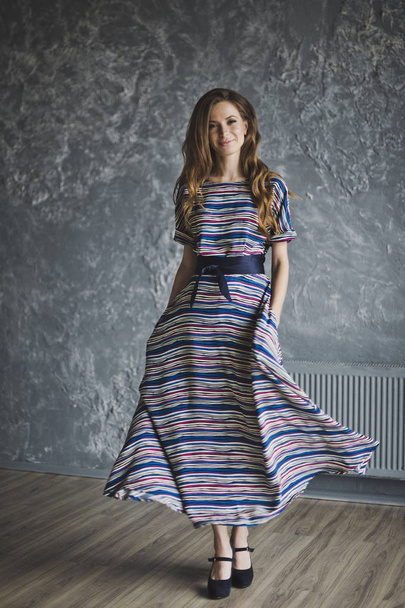Gorgeous slender girl in a striped dress 6982. - Фото, зображення