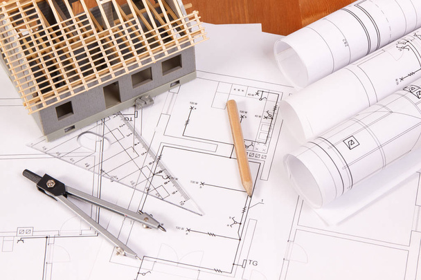 Electrical diagrams, accessories for engineer jobs and house under construction on desk, building home concept - 写真・画像