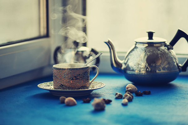 Vintage small cup, with hot coffee and steel teapot  - Фото, зображення