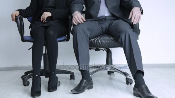 businessman touching leg of female colleague in office. sexual harassment and abuse concept - Кадри, відео
