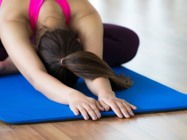 Woman practicing yoga pose in gym - Photo, Image