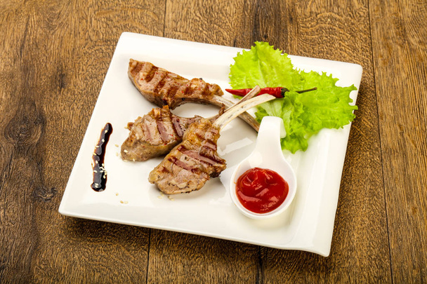 Grilled lamb with tomato sauce served salad leaves - Photo, Image