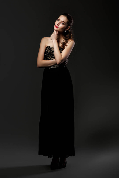 beautiful curly woman in black dress - Fotoğraf, Görsel