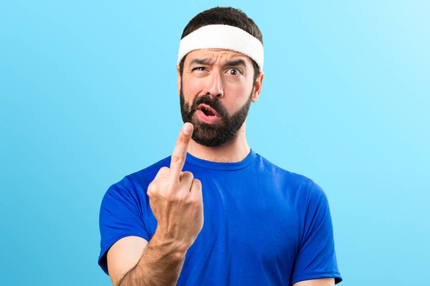 Funny sportsman making horn gesture on colorful background - Foto, immagini