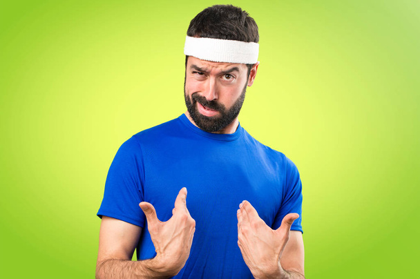 Funny sportsman making surprise gesture on colorful background - Foto, immagini